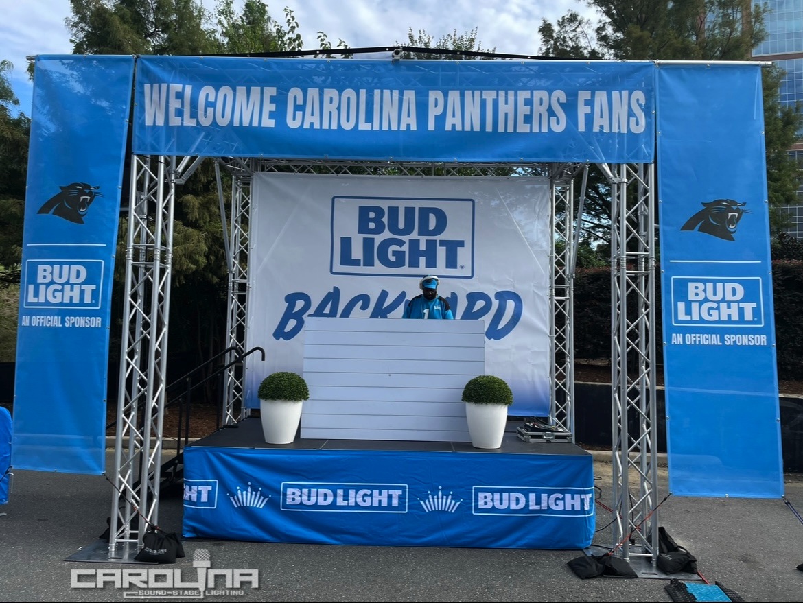 Global Truss structure with stage and pro audio sound package at Carolina Panther Bud Light tailgate event Charlotte Carolina Sound Stage Lighting NC SC corporate event production activation rental